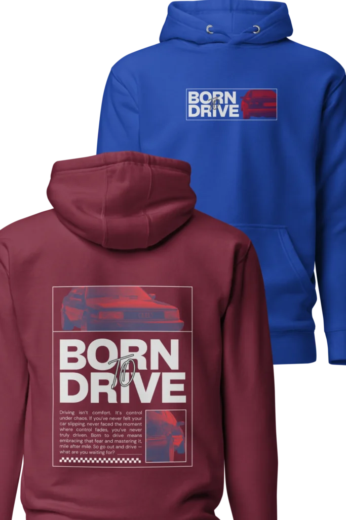 Kaks Born To Drive kapuutsiga pusa, üks sinine tagaplaanil, mis näitab pusa disaini esikülge, kus on väikselt rinna peal BORN TO DRIVE kiri ja Audi 200 tagaosast diagonaalis pilt. Ja ees on ülekattega tumepunane pusa, mis kuvab pusa tagakülje disaini, millele on suurem pilt Audi 200 esiosast, selle all taas suurte tähtedega BORN TO DRIVE kiri ja all motiveeriv tekst, mis on ka kirjas tootekirjelduses. All on veel paremal nurgas valge joonega raami sees paremal Audi tagaosast väiksem ruudukujuline pilt.